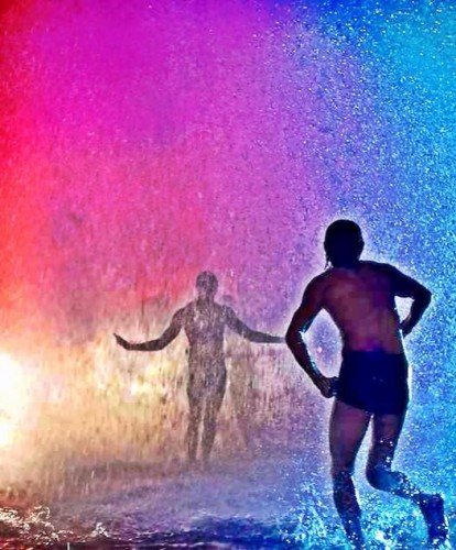 Kids playing in a fire hydrants wake